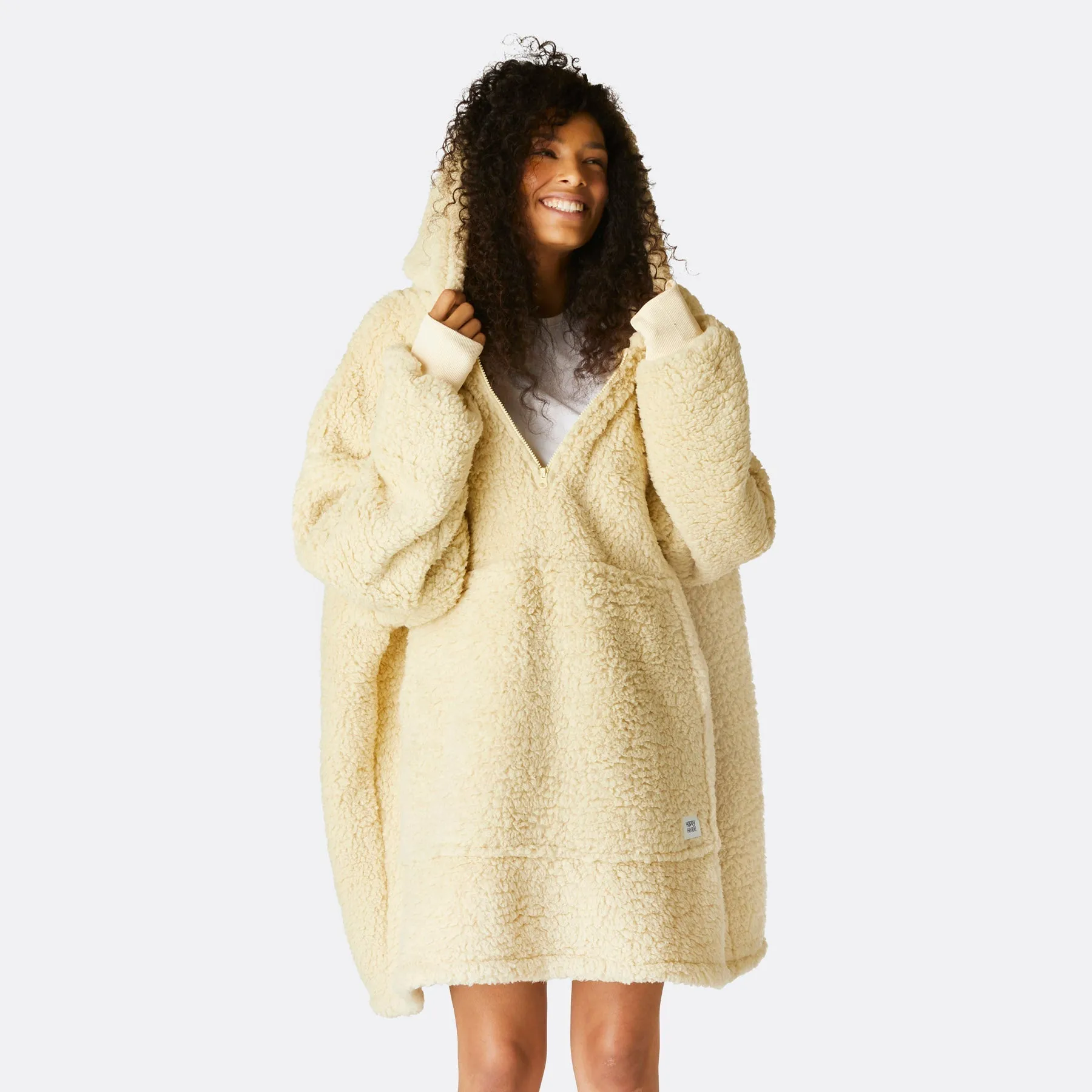 Sure! The optimized title for this e-commerce product could be Cozy Beige Sherpa HappyHoodie.